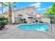 Inviting backyard pool with an attached hot tub, mature landscaping and patio area at 7632 Desert Largo Ave, Las Vegas, NV 89128