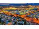 Night aerial view of a vibrant cityscape with illuminated buildings and distant mountains at 801 Sir James Bridge Way, Las Vegas, NV 89145