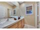 This bathroom features a double sink vanity and a window at 801 Sir James Bridge Way, Las Vegas, NV 89145