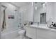 Modern bathroom with a built-in shower-tub combo, large mirror, and floating vanity at 801 Sir James Bridge Way, Las Vegas, NV 89145