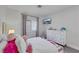 Bright bedroom features a large dresser, a mounted tv, and a window with plantation shutters at 801 Sir James Bridge Way, Las Vegas, NV 89145