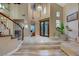 Inviting foyer with a grand staircase, tile flooring, and high ceilings, creating a welcoming and spacious entryway at 801 Sir James Bridge Way, Las Vegas, NV 89145