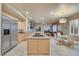 Well-equipped kitchen with stainless steel appliances, an island cooktop, and a view of the living area at 801 Sir James Bridge Way, Las Vegas, NV 89145