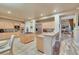 Spacious kitchen featuring stainless steel appliances, an island cooktop, and a view into the living area at 801 Sir James Bridge Way, Las Vegas, NV 89145