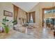 Spacious living room with stone accent wall, plush seating, and an abundance of natural light at 801 Sir James Bridge Way, Las Vegas, NV 89145