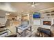 Open-concept living room seamlessly connecting the kitchen, dining area, and a cozy fireplace, perfect for gatherings at 801 Sir James Bridge Way, Las Vegas, NV 89145