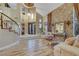 Elegant living room with a stone accent wall, high ceilings, and an open layout, providing a sophisticated and inviting space at 801 Sir James Bridge Way, Las Vegas, NV 89145