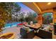 Outdoor living space features a built in grill, firepit, and pool views at 801 Sir James Bridge Way, Las Vegas, NV 89145