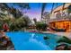 An in ground pool features mature landscaping and a built in spa at 801 Sir James Bridge Way, Las Vegas, NV 89145