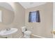 Powder room featuring a pedestal sink, window, and toilet at 8112 Mustang Hill Ct, Las Vegas, NV 89131