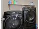 Black Samsung washer and dryer set with shelf above at 8112 Mustang Hill Ct, Las Vegas, NV 89131