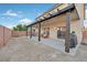 Covered backyard patio featuring furniture and a low-maintenance gravel landscape at 8112 Mustang Hill Ct, Las Vegas, NV 89131