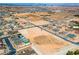 Aerial view showcasing a developing community with homes and empty lots surrounded by desert landscaping at 8825-3 S Monte Cristo Way, Las Vegas, NV 89113