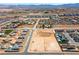 An aerial view showing a vacant lot among a neighborhood of modern homes and desert landscaping at 8825-4 S Monte Cristo Way, Las Vegas, NV 89113