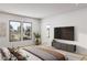 Bright bedroom featuring large windows, a TV, and a serene aesthetic with neutral tones at 8825-4 S Monte Cristo Way, Las Vegas, NV 89113