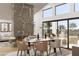 Elegant dining room with marble table, fireplace, and sliding glass doors to an outdoor space at 8825-4 S Monte Cristo Way, Las Vegas, NV 89113