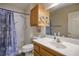 Well-lit bathroom with a shower, toilet, and vanity sink at 8916 Evening Star Dr, Las Vegas, NV 89134