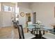 Bright dining area with a round glass table, seating four, next to a front entryway at 8916 Evening Star Dr, Las Vegas, NV 89134