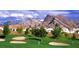 Picturesque community golf course showcasing mountain views, sand traps, and immaculate green at 8916 Evening Star Dr, Las Vegas, NV 89134