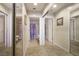 Hallway with tiled flooring, mirrored closet doors, and doorways leading to the bathroom at 8916 Evening Star Dr, Las Vegas, NV 89134