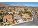 Wide aerial shot with desert mountains in the background and nearby lush landscaping at 941 Armandito Dr, Las Vegas, NV 89138