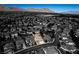 An aerial view showcases this desert home surrounded by neutral colored homes and mountain views at 941 Armandito Dr, Las Vegas, NV 89138