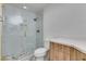 Modern bathroom featuring a glass enclosed shower with marbled tile and a wood vanity with a stone countertop at 941 Armandito Dr, Las Vegas, NV 89138