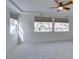 Spacious bedroom with plush carpeting, recessed ceiling, ceiling fan, and large windows providing ample natural light at 941 Armandito Dr, Las Vegas, NV 89138