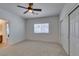 Carpeted bedroom with a ceiling fan, double door closet, and natural light at 941 Armandito Dr, Las Vegas, NV 89138