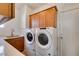 A laundry room featuring a stacked washer and dryer, cabinetry and a sink with counter space at 941 Armandito Dr, Las Vegas, NV 89138