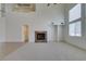 Open-concept living room with a fireplace, bright light, and neutral color palette at 941 Armandito Dr, Las Vegas, NV 89138