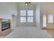 Bright living room featuring high ceilings, a ceiling fan, and a cozy fireplace at 941 Armandito Dr, Las Vegas, NV 89138