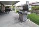 The backyard features a stainless steel barbecue grill on wheels and a covered patio area at , Las Vegas, NV 89118