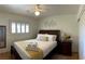 This bedroom features a light wood floor, shuttered window, and a queen bed with dark wood frame at , Las Vegas, NV 89118