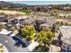 Aerial view of a home with a tile roof, surrounded by lush greenery, and a golf course nearby at 1 Ibis Ct, Henderson, NV 89052