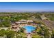 Breathtaking aerial view of community pool, surrounding houses, and lush golf course showcasing upscale living and recreation at 1 Ibis Ct, Henderson, NV 89052
