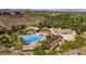 Breathtaking aerial view of community pool, surrounded by lush green landscape, homes and trees on a sunny day at 1 Ibis Ct, Henderson, NV 89052
