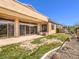 Covered patio extends to a green lawn, providing an inviting outdoor living space at 1 Ibis Ct, Henderson, NV 89052