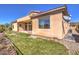 Home's backyard featuring a grassy area and desert landscaping, ideal for outdoor enjoyment at 1 Ibis Ct, Henderson, NV 89052