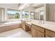Bright bathroom with dual sinks, garden tub and large windows at 1 Ibis Ct, Henderson, NV 89052