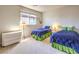 Bedroom featuring two twin beds with blue bedding, accent pillows and a chest of drawers at 1 Ibis Ct, Henderson, NV 89052