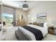Bright bedroom features a large bed, dresser with round mirror and access to the patio at 1 Ibis Ct, Henderson, NV 89052