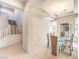 Bright dining room with glass table, chandelier, and staircase access at 1 Ibis Ct, Henderson, NV 89052