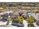 An aerial view reveals a luxurious home with a pool and a backdrop of scenic desert landscape at 1 Ibis Ct, Henderson, NV 89052