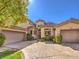 Home with a three-car garage, well-kept landscaping, and a stone driveway on a sunny day at 1 Ibis Ct, Henderson, NV 89052