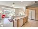 Bright open kitchen features tile flooring, breakfast bar, and stainless steel dishwasher at 1 Ibis Ct, Henderson, NV 89052
