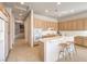 A well-lit kitchen is equipped with wooden cabinets and a spacious breakfast bar at 1 Ibis Ct, Henderson, NV 89052