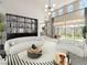 Sun-filled living room with high ceilings, modern shelving, and contemporary furniture at 1 Ibis Ct, Henderson, NV 89052