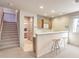 Living room with a bar area, seating for two, and staircase at 1 Ibis Ct, Henderson, NV 89052
