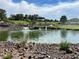 Scenic view of a community pond with a fountain and lush landscaping and golf course in the background at 1 Ibis Ct, Henderson, NV 89052